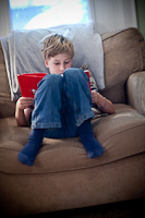 Noah reading in a chair