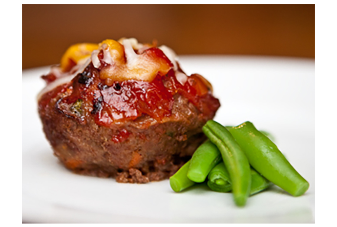 Kids like their own mini version of everything big so we made mini meatloaf muffins. They're easy to eat and baked in a muffin tin topped with cheese and salsa.   