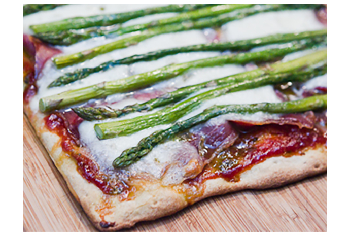 Impress your family and friends with this easy-to-make and easy-to-fake gourmet pizza starter. Be sure to line up the asparagus just so and top with arugula for restaurant quality presentation.