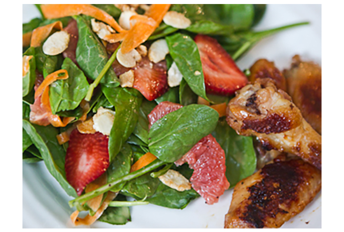 Think of this spinach salad as a platter filled with fruits, nuts, and a bit of spinach with a side of chicken wings. There is sure to be something on the plate your kids will love and they might even pick up some spinach along the way.
