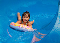 Girl on blue water slide