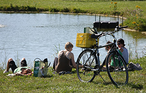 Family with bikes by pond