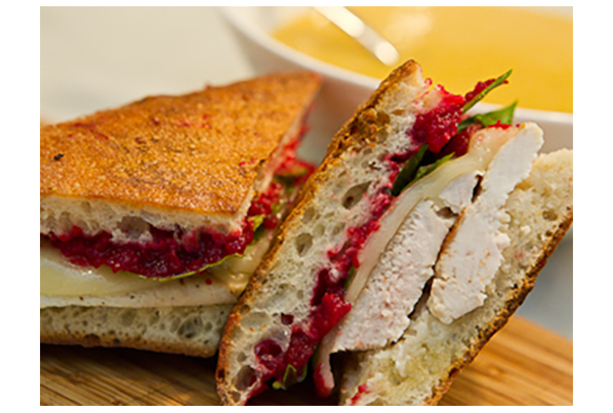 The best part of this recipe is in the cranberry relish. This sweet sandwich spread is so delicious we could eat it with a spoon but it's just perfect in a grilled panini. No other condiments required.