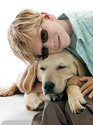 Boy with his dog wearing Transitions glasses