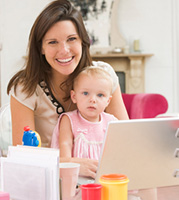Mom with baby on lap at laptop