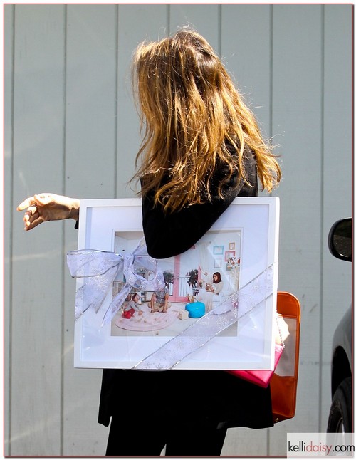 &quot;Sin City&quot; star Jessica Alba heads into her office carrying a brand new, framed family portrait on March 20, 2012 in Santa Monica, CA. The portrait features her, her husband Cash and their children Honor and Haven having a family moment. Will she hang that portrait above her desk?