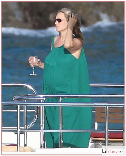 Pregnant actress Uma Thurman enjoying a vacation with her kids Maya and Levon Hawke and her mother Nena von Schlebrugge on a yacht in St. Barts, France on March 24, 2012. Uma did some stretching before pounding a glass of wine. Afterwards she took a dip in the ocean and helped her son wash off after his swim