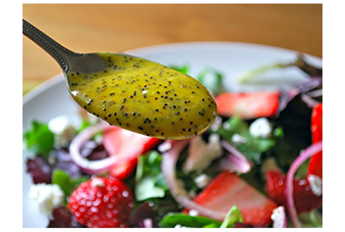 Baby greens are in season this month, which means it's time to add salads back into the weekly meal plan. Here, the little leaves are tossed with sliced strawberries, tangy goat cheese and maple-sweetened pecans, then dressed with a honey-infused mango poppy seed dressing. 