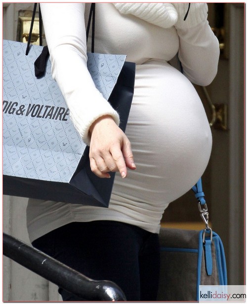 Pregnant Alyson Hannigan and her husband Alexis Denisof out shopping with their daughter Satyana in New York City, New York on April 10, 2012.