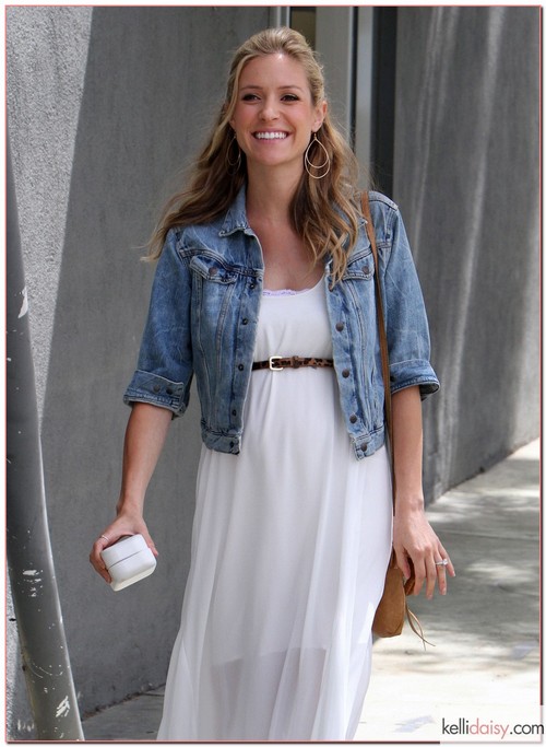 Mom-to-be Kristin Cavallari was out and about in Los Angeles, California on April 11, 2012 wearing a long white dress with a jean jacket that showed off her growing baby bump. She arrived at the Crossroads Trading Co. to drop off bags of clothes with the help of a friendly photographer who unloaded the large bags for her.