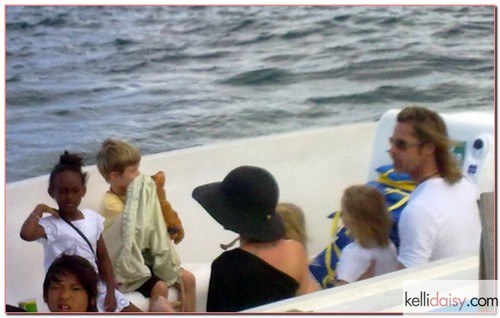 Recently engaged superstars Brad Pitt and Angelina Jolie and their children get off a boat on April 23, 2012 as they vacation in the Galapagos Islands.