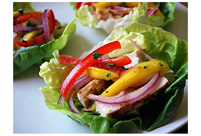 Put an extra spring in your step this month by swapping traditional breads and buns for crispy lettuce wraps in this updated wrap. The sweet mango and slightly spicy red onion complement the grilled chicken perfectly, making this a perfect pre-baseball (or soccer) dinner. 