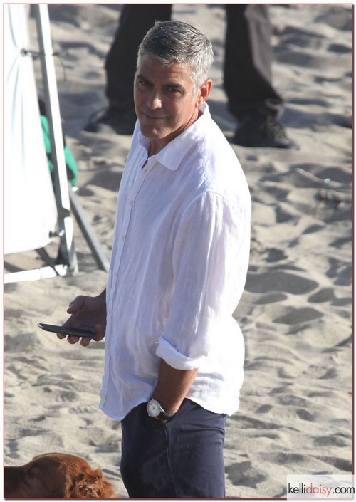 Actor George Clooney enjoying his new best friend on the set of an Italian TV commercial on the beach in Malibu, California on May 15, 2012