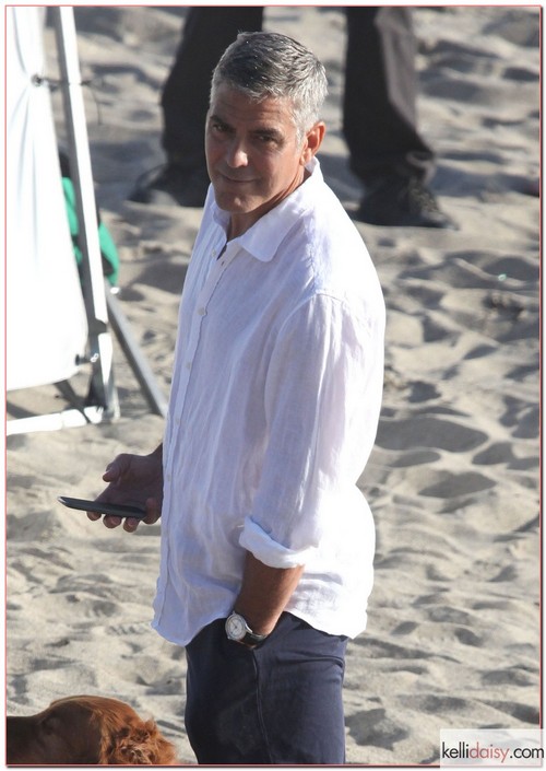 George Clooney Showing Off His New Best Friend Actor George Clooney enjoying his new best friend on the set of an Italian TV commercial on the beach in Malibu, California on May 15, 2012
