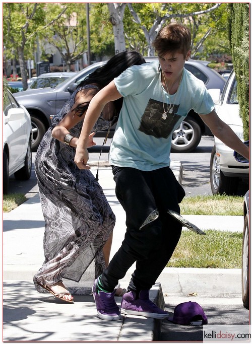 Justin, aka &quot;The Biebs&quot;, Bieber went bonkers on a photographer while out with his lovely lady Selena Gomez in Los Angeles, CA on May 27th, 2012. The usually cool, calm and collected singing sensation simply lost it for a moment and lost his shoe and hat in the melee. Lady Selena was there to recover his lost items and help a seemingly uninjured Justin away but then she got to deal the craziness which ensued. Fire trucks, cops and an ambulance were called to the scene and paramedics tended to the photog who was still on the ground.