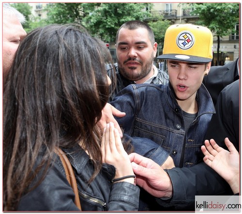 Singer Justin Bieber is mobbed by fans upon his arrival in Paris, France on May 31, 2012. After posing for a picture with the Biebs, a female fan touches his face and Justin's security team quickly pushes her away. Fortunately for the fan, Justin didn't unleash his fists of fury on her- since, as we've seen recently, one punch from the Biebs could land you in the hospital... RESTRICTIONS APPLY: USA/AUSTRALIA ONLY