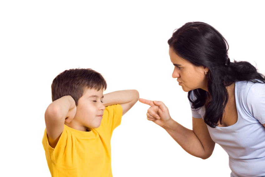 Mother scolding her son with pointed finger