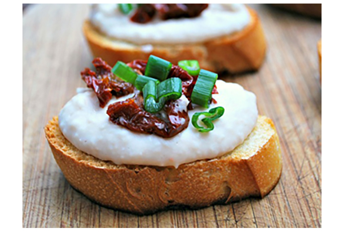 No-cook appetizers are an essential when entertaining this holiday season. Feel free to puree the bean mixture in advance and dress the tops of these toasts with sundried tomatoes, fresh herbs or olives. 