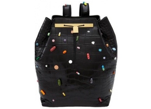 a leather knapsack dotted with pills