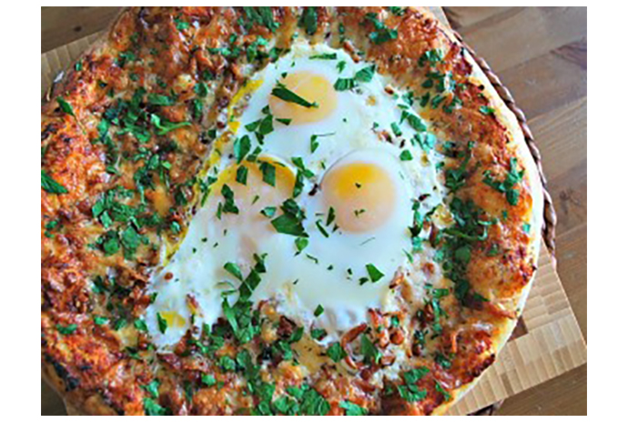 Breakfast for dinner takes on a new meaning when your favourite morning meal ingredients—crispy bacon and baked eggs—are scattered over a golden pizza crust and topped with gooey cheeses. Feel free to make individual pizzas in lieu of one large one, and encourage your family to get creative with their toppings by adding breakfast sausage or potato pieces to the mix. 