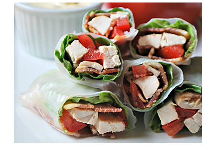 The traditional club sandwich gets a gluten-free makeover in these Asian chicken club wraps. Rice paper rolls envelop five-spice-laced bacon, sliced chicken, crisp lettuce and thinly sliced tomatoes for an easy dinner the whole family will enjoy. 