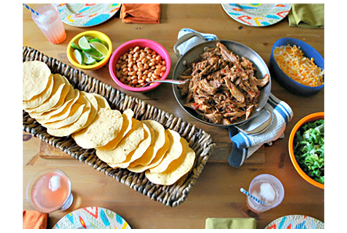 For warm-weather, family-friendly entertaining, a DIY Mexican tostada bar is just the thing to keep everyone happy. This self-serve meal is designed for easy preparation (hello, slow cooker!), and everyone, regardless of age, is certain to find something appealing among the fixings.