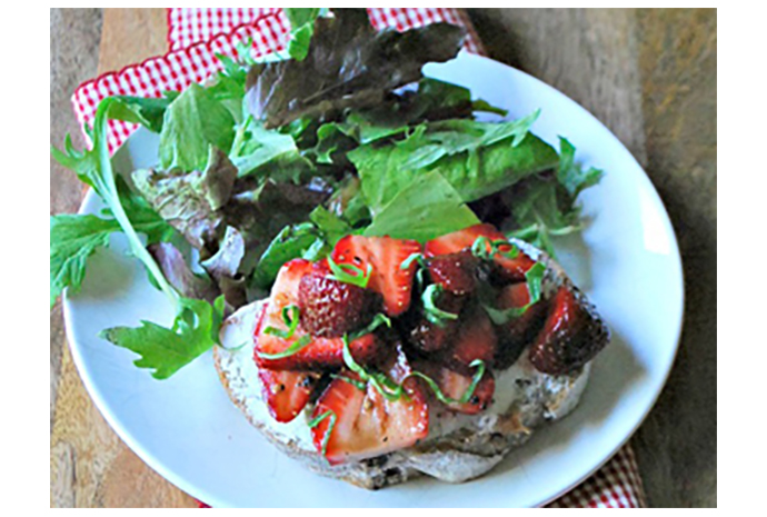 Slightly saucy berries served over goat-cheese-topped bread is a summer dish worth serving at any dinner party. The sweetness of the strawberries pairs perfectly with the tangy goat cheese, and it's an ideal starter or appetizer for sunny-season gatherings.