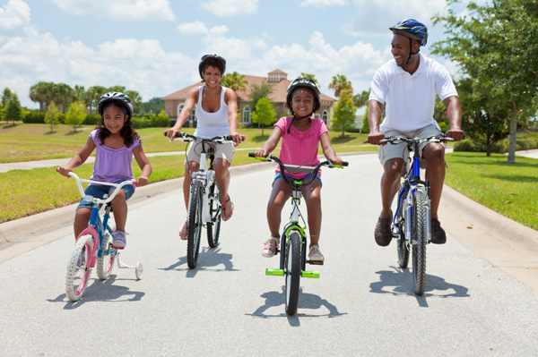 family-riding-bikes-street