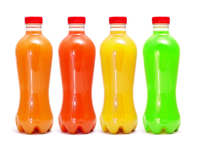 some bottles of different colors with different juices on a white background