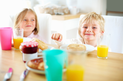 Portrait of brother and sister having their breakfast together