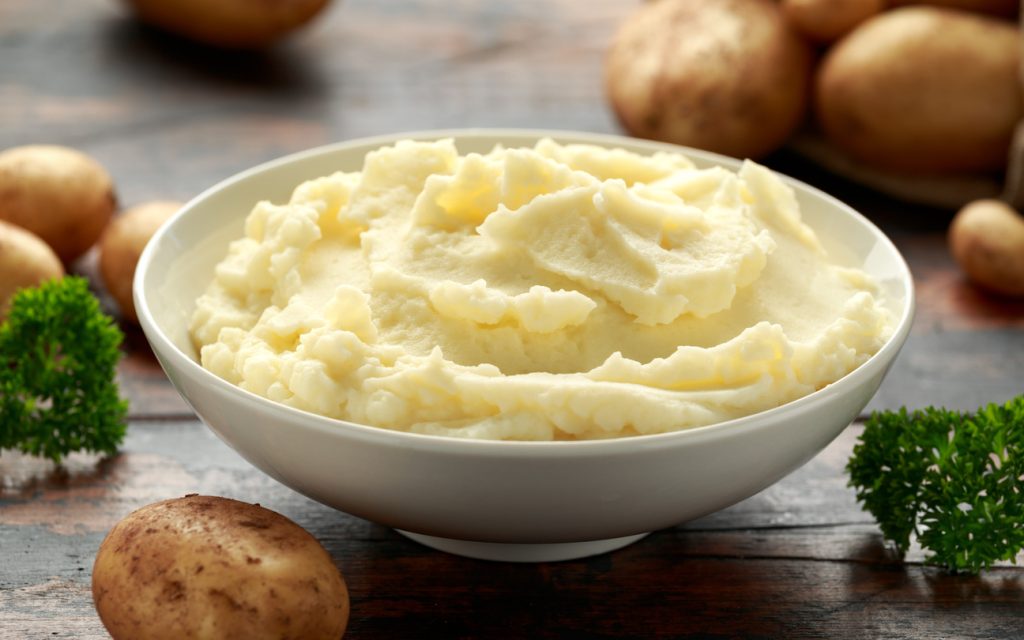 Mashed potatoes in white bowl on wooden rustic table. Healthy food Perfect Mashed Potatoes Recipe - SavvyMom