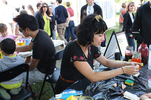Photo of Kristiann Boos, Etsy seller, running a DIY fabric dyeing workshop at Queen West Arts Crawl in 2012