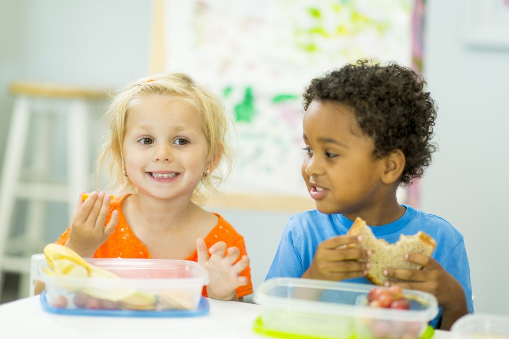 Preschoolers eating snack.