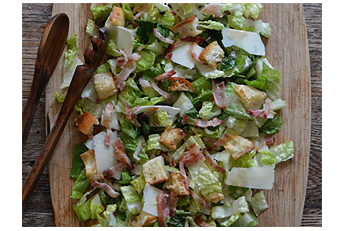 The charred edges, wilted leaves and crisp core make this updated version of the classic Caesar salad memorable. Like all Caesar salads, it's best served as soon as the leaves are dressed. Top the salad with sliced chicken breast, hard-boiled egg slices, shrimp, or sliced steak for a complete meal that's ideal for warm-weather cooking.