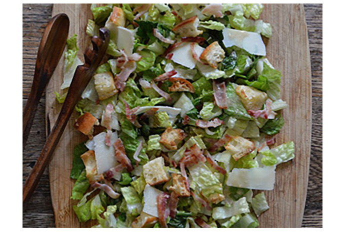 Grilled Caesar Salad The charred edges, wilted leaves and crisp core make this updated version of the classic Caesar salad memorable. Like all Caesar salads, it's best served as soon as the leaves are dressed. Top the salad with sliced chicken breast, hard-boiled egg slices, shrimp, or sliced steak for a complete meal that's ideal for warm-weather cooking.