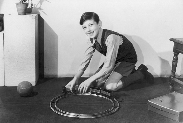 "A hobby that lasts a boy for a  very long time - trains! He  can develop his hobby until he  reaches the standard of model  railway societies - a lif     Date: circa 1950     Source: Unattributed photograph for Barnaby's Studios Ltd