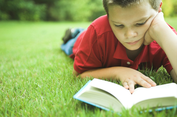 boy-reading-book-outside boy-reading-book-outside