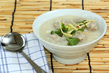 Traditional chinese porridge rice gruel in bowl with pork