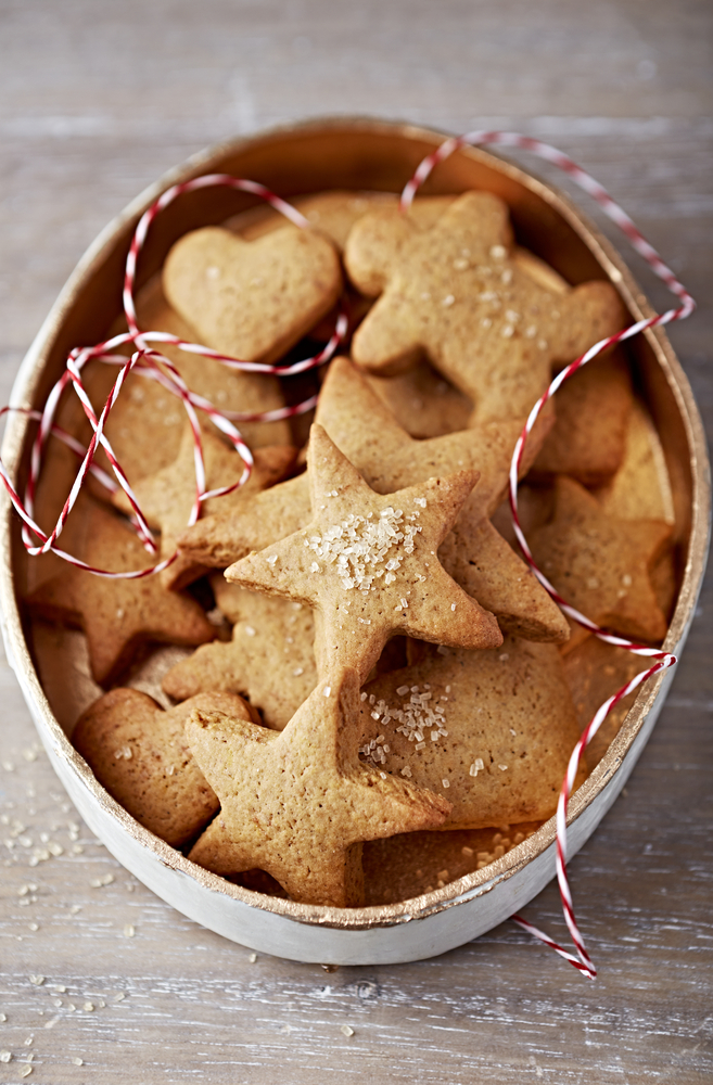 Tips for cookie swap, gingerbread star-shaped cookies in a holiday tin