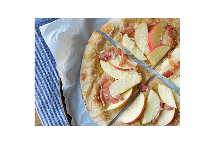 Homemade pizza will always be better for the kids than take out, but this month's variation is a tasty surprise that swaps in a whole-wheat pita for the traditional bready crust, and includes a generous serving of fruit thanks to the addition of crisp apple slices.
