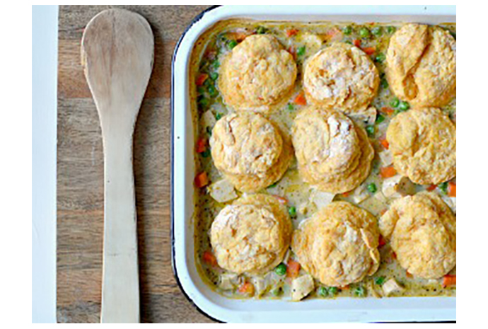 Our simple, quick-cooking chicken pot pie gets a healthy makeover while still offering the homey comfort you crave this time of year. By simply swapping chicken stock for cream and topping the dish with our homemade, whole-wheat, sweet potato biscuits instead of puff or pie pastry, this lightened-up version hits all the notes of the classic. 
