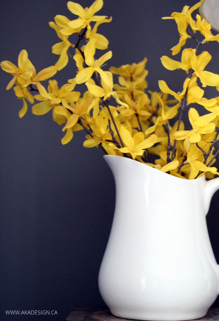 YELLOW-FLOWERS-WHITE-PITCHER-GREY-WALL