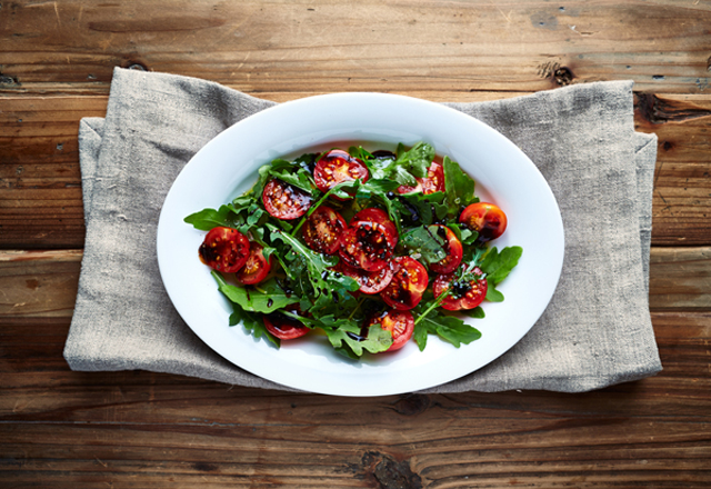 Arugula salad with cherry tomatoes and balsamic vinegar