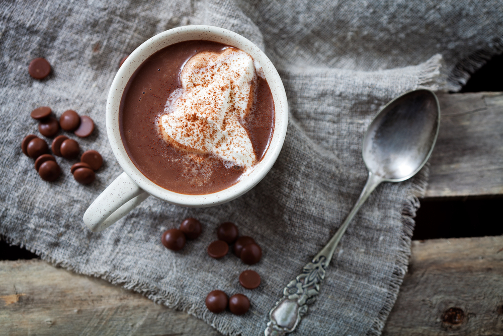 Mug of sliced hot chocolate with whipped cream