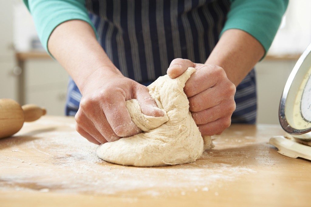 Close Up Of Hands Kneading Dough