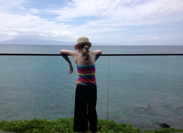 Girl-looking-at-ocean-from-balcony