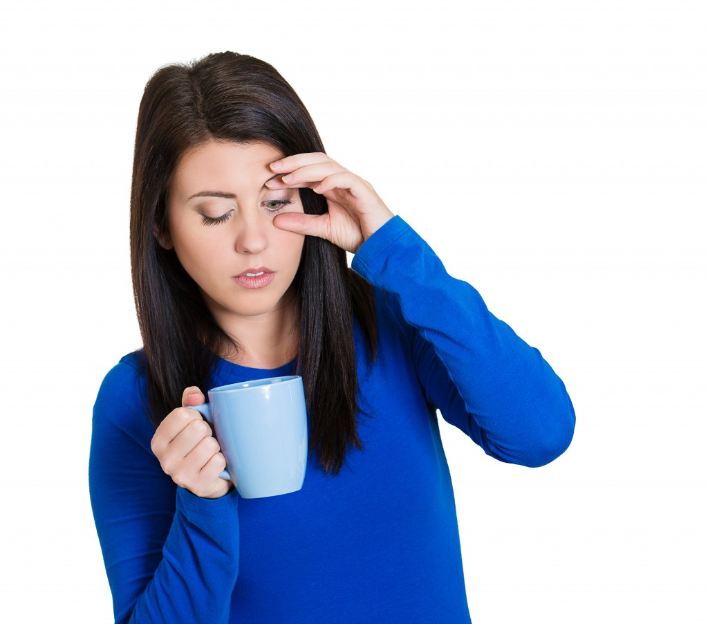 Portrait tired falling asleep woman employee holding cup coffee
