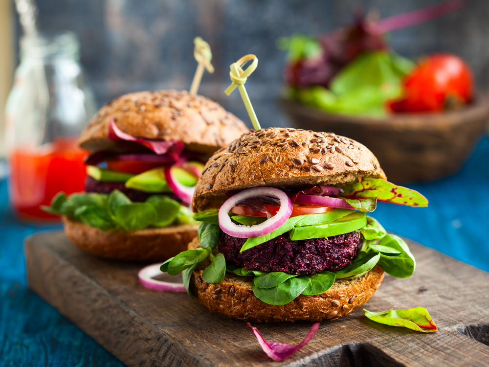 10 Best Vegetarian Burgers, 2 veggie burgers on wood cutting board