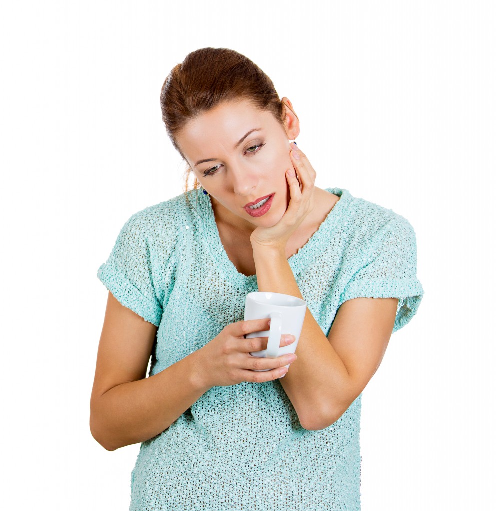 Closeup portrait sleepy young woman holding cup, about to crash, fall asleep eyes closed, looking bored, isolated white background. Negative human emotion, facial expressions, feelings, signs, symbols