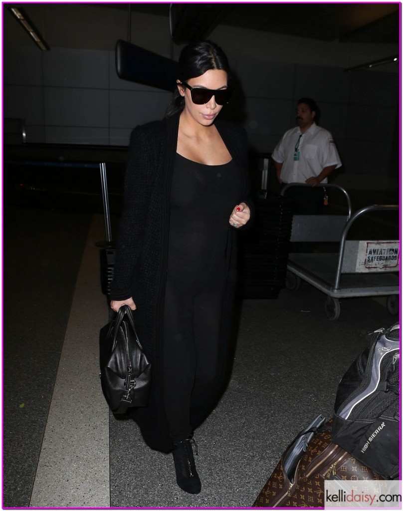 51805835 Pregnant reality star kim Kardashian arriving on a flight at LAX airport in Los Angeles, California on July 22, 2015. Kim, who is currently pregnant with her second child, hid her growing baby bump under a tight black jumpsuit. FameFlynet, Inc - Beverly Hills, CA, USA - +1 (818) 307-4813